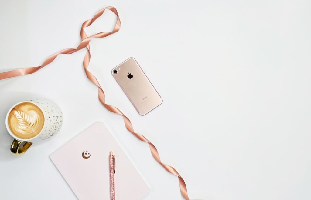 silver iphone 6 on white surface